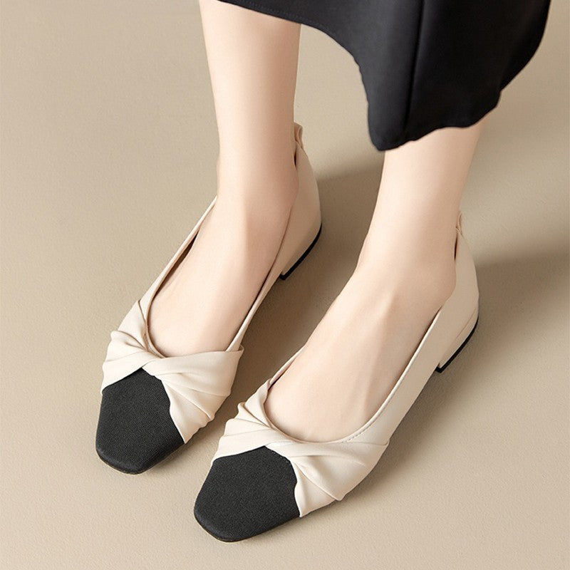Elegant women's low heel shoes in soft leather with chic pointed toe and twisted strap design, perfect for any occasion.
