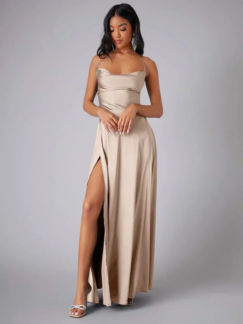 Elegant women's maxi dress with high slit and open back, featuring a figure-flattering silhouette and criss-cross design.