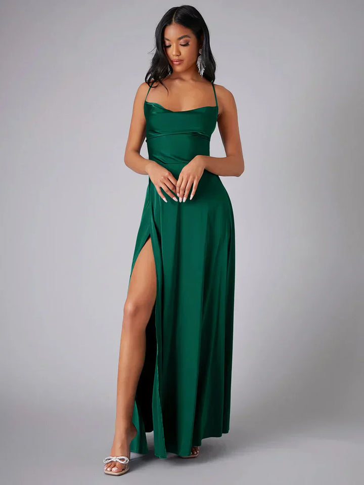 Elegant women's maxi dress with high slit and open back, featuring a figure-flattering silhouette and criss-cross design.