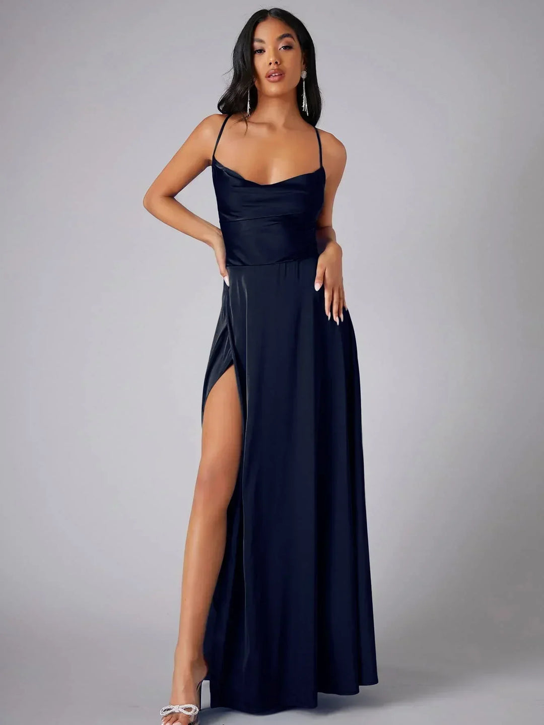 Elegant women's maxi dress with high slit and open back, featuring a figure-flattering silhouette and criss-cross design.