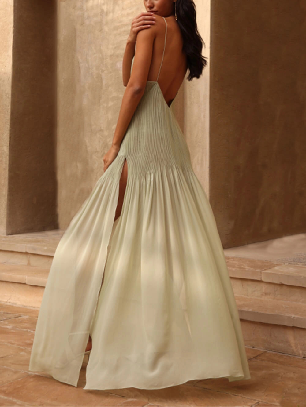 Elegant women's pleated maxi dress with spaghetti straps and front slit, showcasing a sophisticated evening look.
