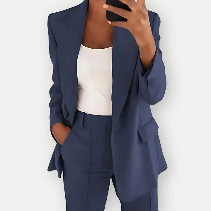 "Elegant women's tailored blazer and trousers set, sleek polyester with sharp lapels, ideal for business and casual wear."