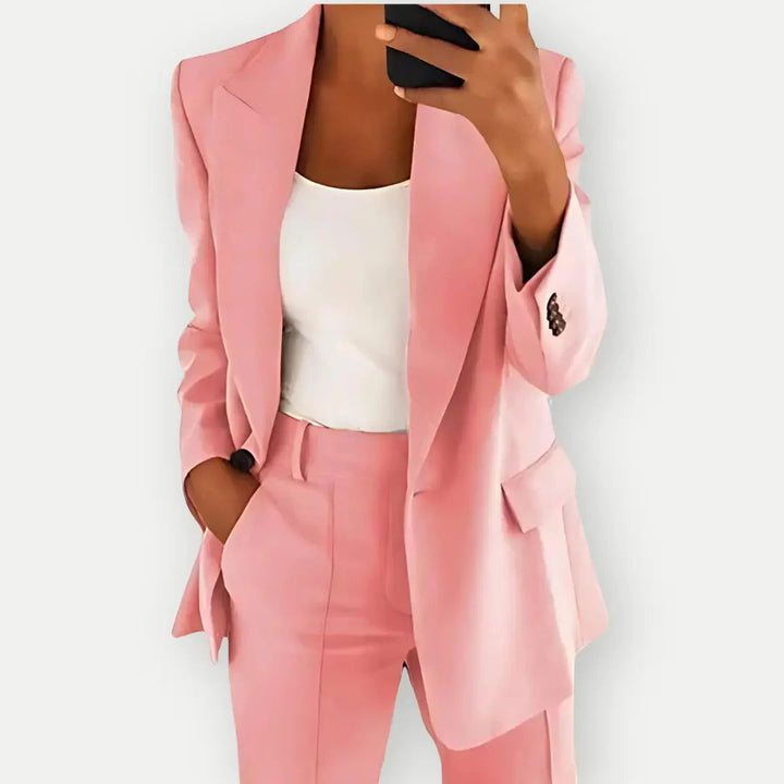 "Elegant women's tailored blazer and trousers set, sleek polyester with sharp lapels, ideal for business and casual wear."