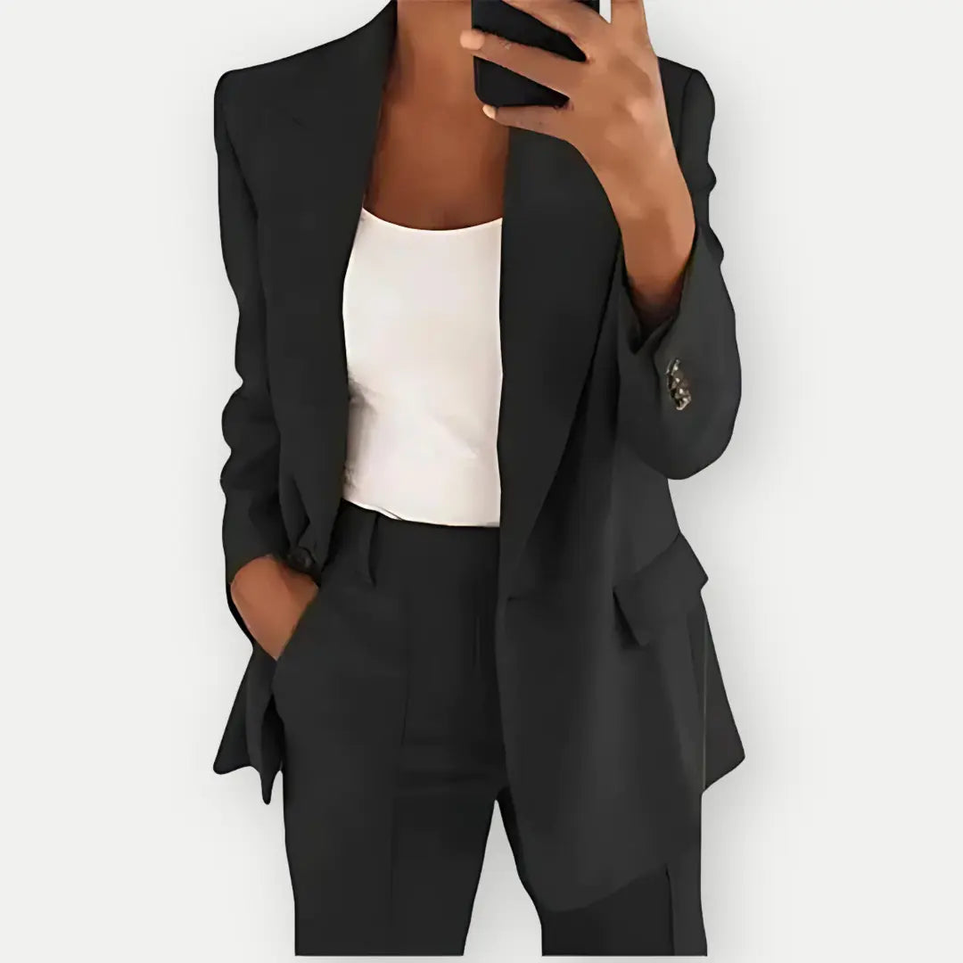 "Elegant women's tailored blazer and trousers set, sleek polyester with sharp lapels, ideal for business and casual wear."