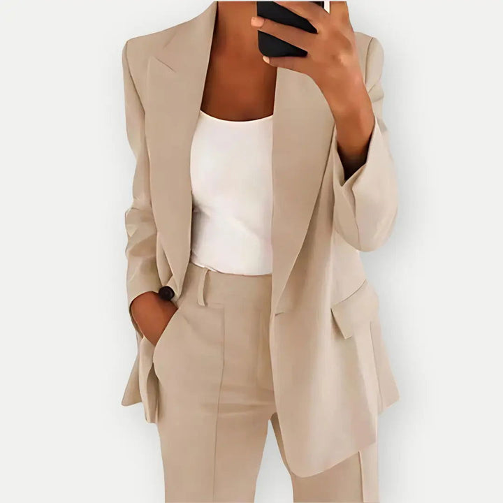 "Elegant women's tailored blazer and trousers set, sleek polyester with sharp lapels, ideal for business and casual wear."