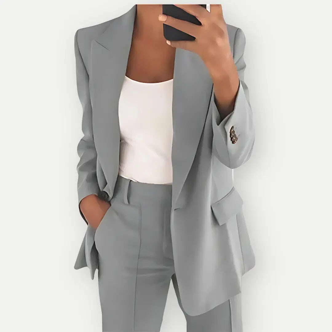 "Elegant women's tailored blazer and trousers set, sleek polyester with sharp lapels, ideal for business and casual wear."