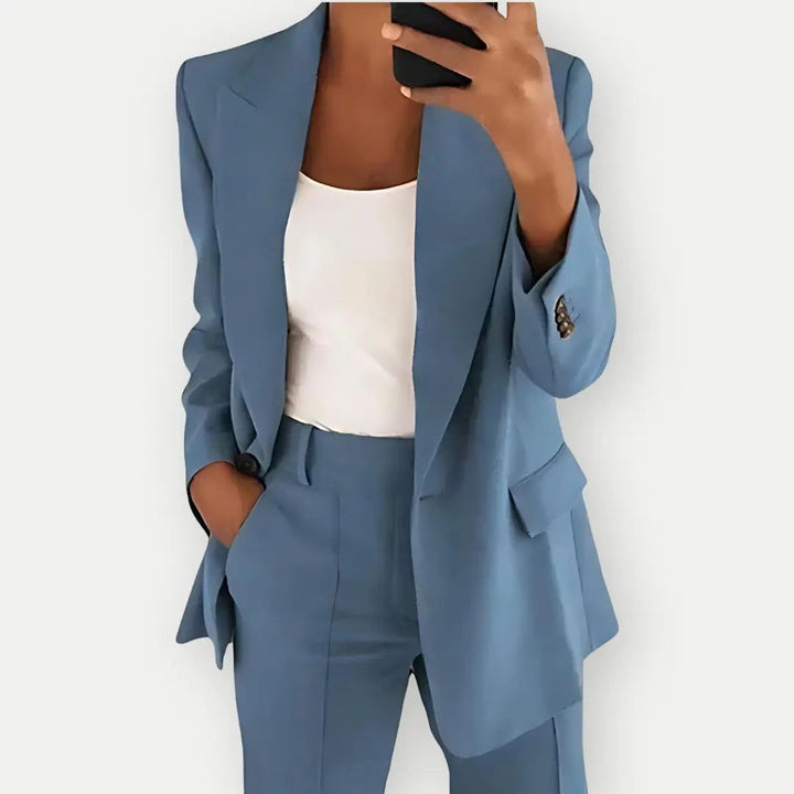 "Elegant women's tailored blazer and trousers set, sleek polyester with sharp lapels, ideal for business and casual wear."
