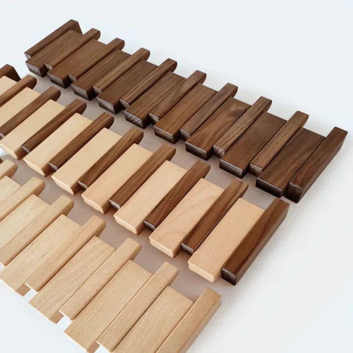 "Elegant wooden coat rack with piano key design, featuring multiple hooks for organizing coats and accessories."