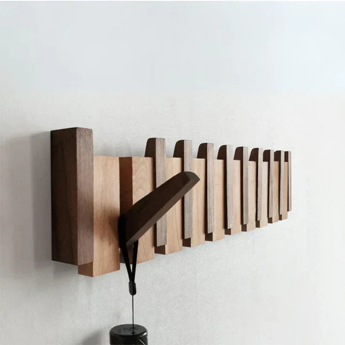 "Elegant wooden coat rack with piano key design, featuring multiple hooks for organizing coats and accessories."