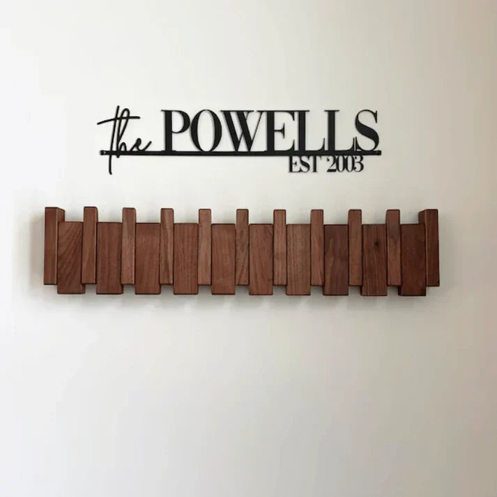 "Elegant wooden coat rack with piano key design, featuring multiple hooks for organizing coats and accessories."