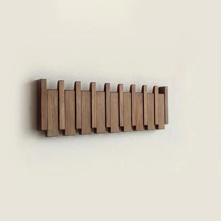"Elegant wooden coat rack with piano key design, featuring multiple hooks for organizing coats and accessories."