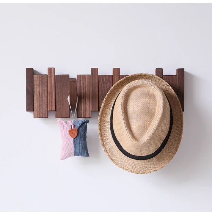 "Elegant wooden coat rack with piano key design, featuring multiple hooks for organizing coats and accessories."