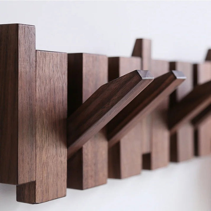 "Elegant wooden coat rack with piano key design, featuring multiple hooks for organizing coats and accessories."