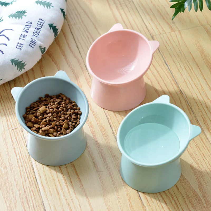 "Ergonomic cat bowl with anti-spill design, 15-degree tilt, high edges, available in pink, green, grey, for pet dining."
