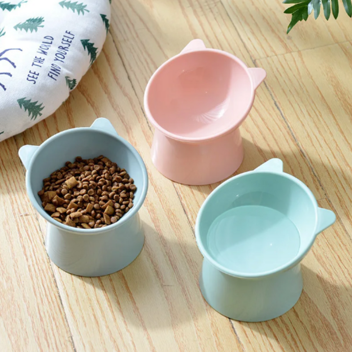 "Ergonomic cat bowl with anti-spill design, 15-degree tilt, high edges, available in pink, green, grey, for pet dining."