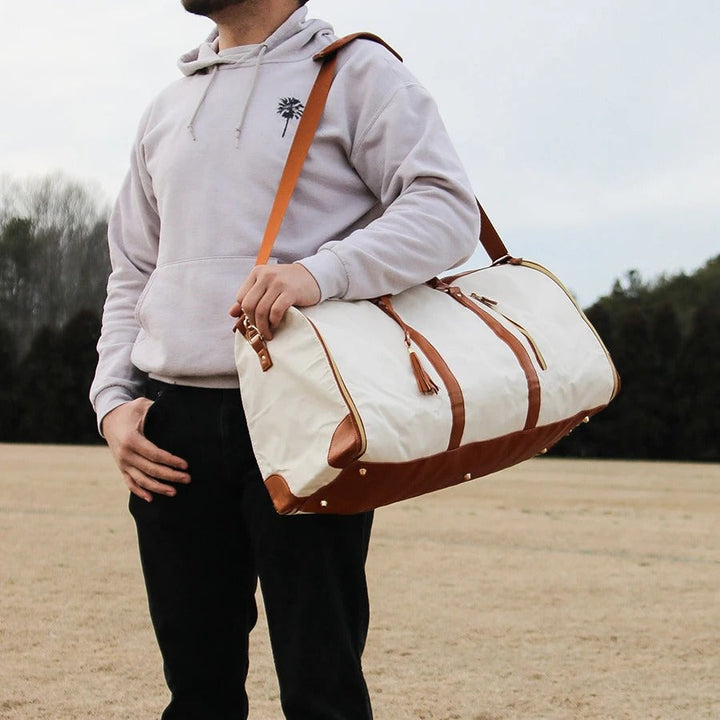"Foldable smart carry-on bag with sleek design, multi-compartment storage, vegan leather, and garment cover for travel."
