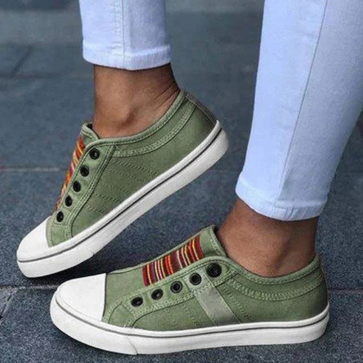 "Grey sneakers for women, stylish and comfy, perfect for everyday wear with a modern look and cushioned soles."