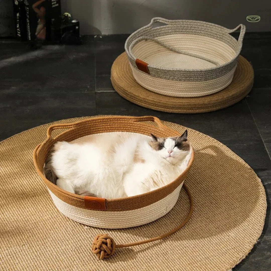 "Handwoven cotton rope cat bed with high sides in neutral tones, offering ultimate comfort and security for cats."