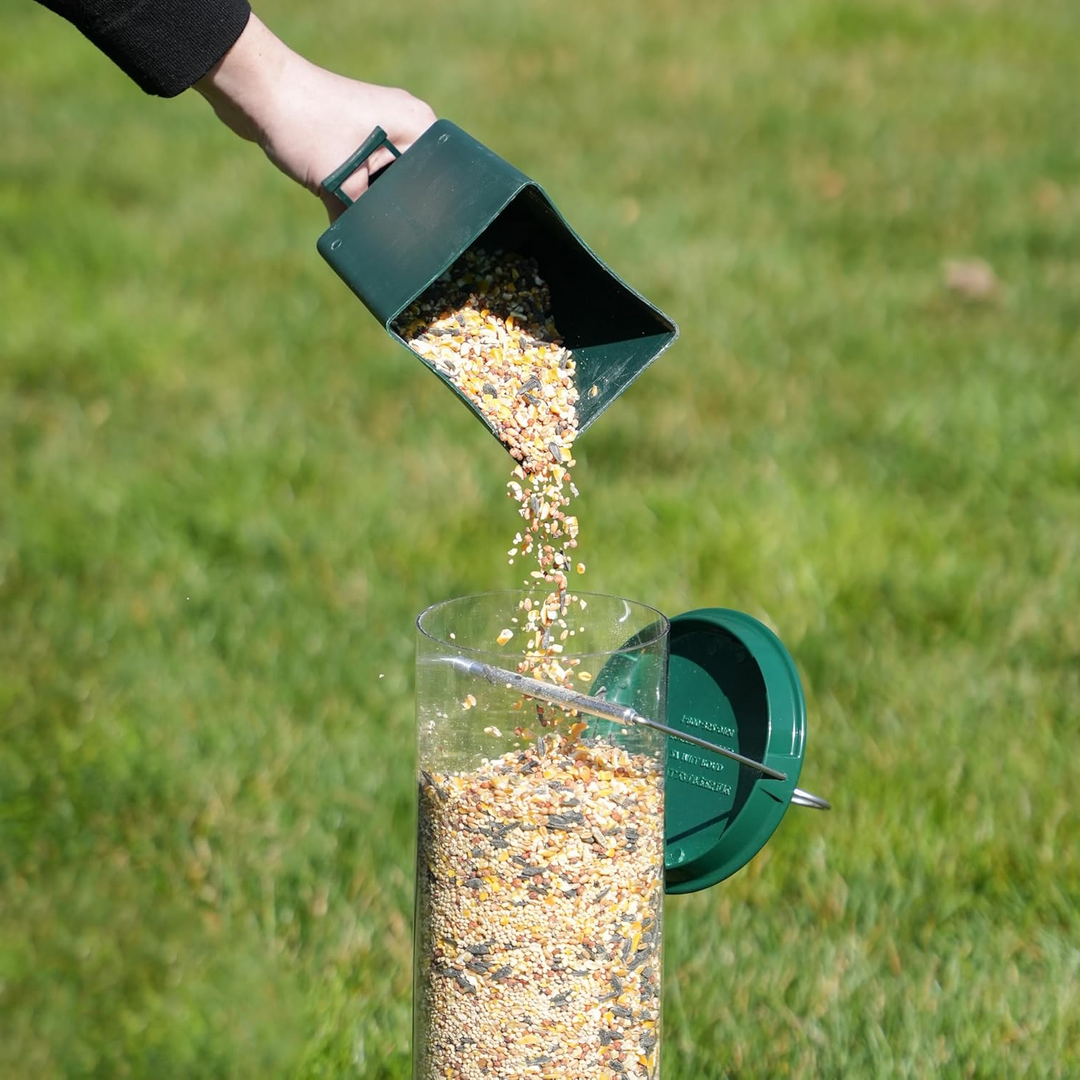 "Heavy-duty squirrel-proof bird feeder with metal weather-resistant design and rotating perch in garden setting."