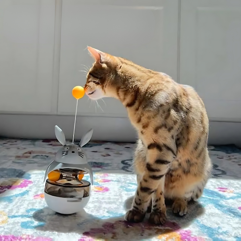 "Interactive cat toy with treat puzzle, features a dynamic design and movable balls for mental stimulation and exercise."