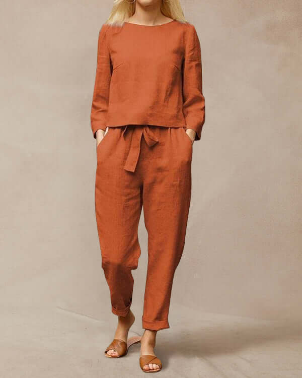Ivory women's linen two-piece set with round neck top and pants, showcasing luxurious texture and elegant style.