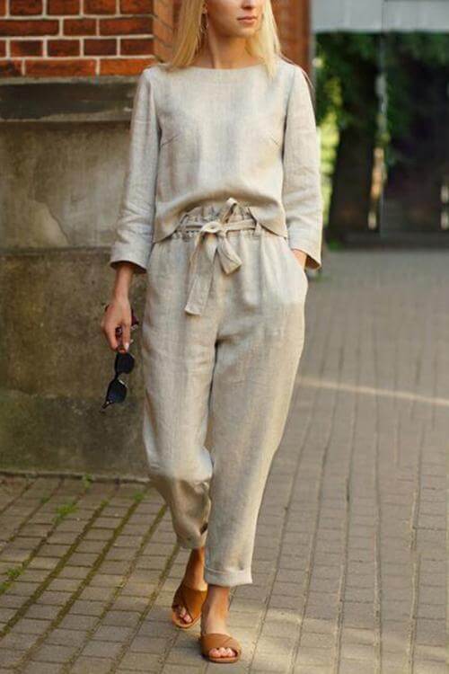 Ivory women's linen two-piece set with round neck top and pants, showcasing luxurious texture and elegant style.