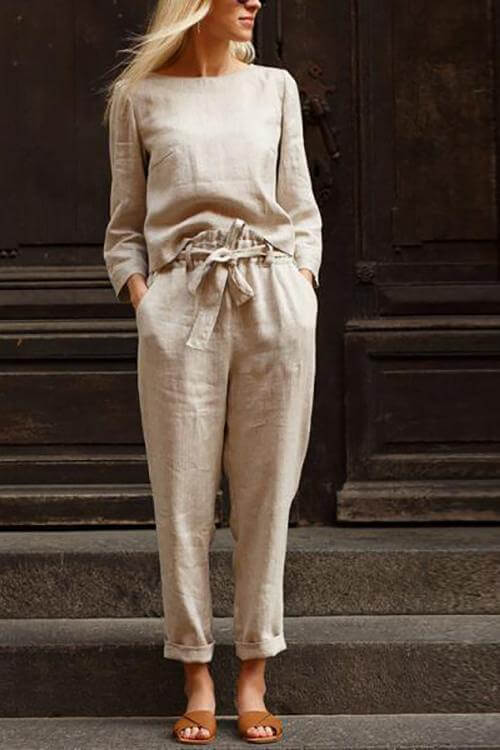 Ivory women's linen two-piece set with round neck top and pants, showcasing luxurious texture and elegant style.