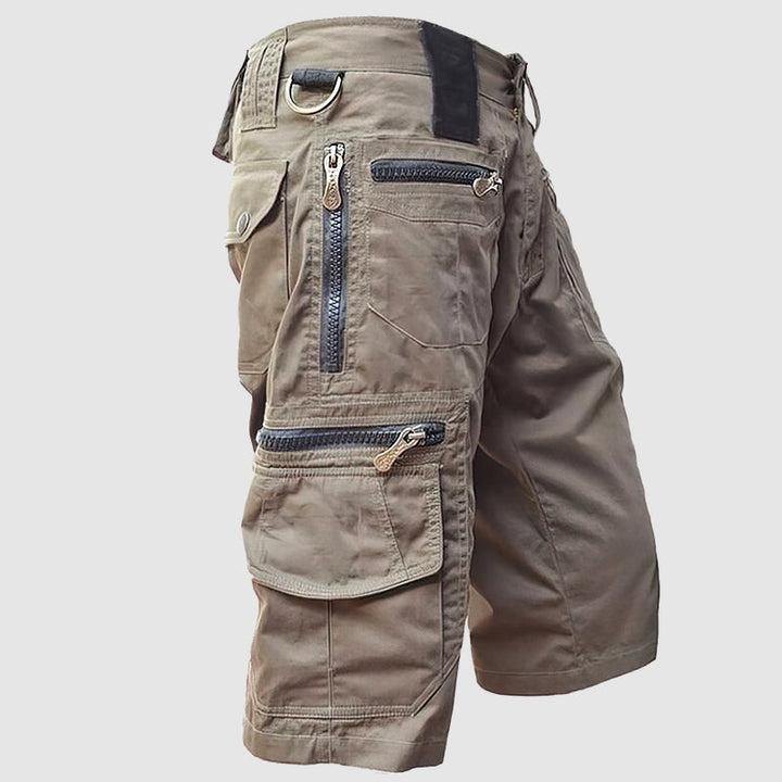 Knee-length men’s cargo shorts in durable cotton with multiple utility pockets, side view for outdoor style and function.