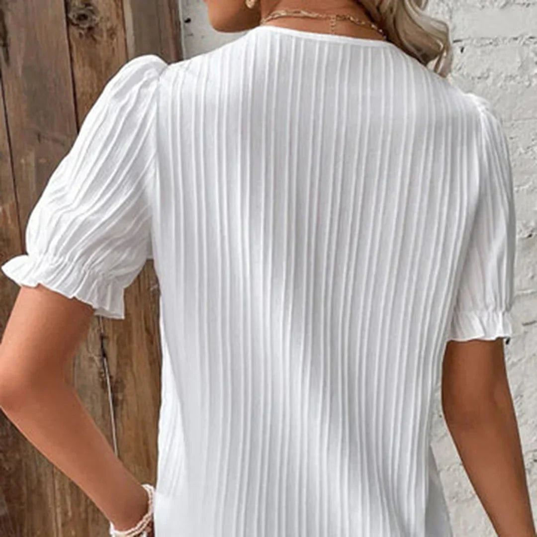 Lace V-neck blouse with short puffed sleeves, pleated fabric, women's elegant clothing, front view.