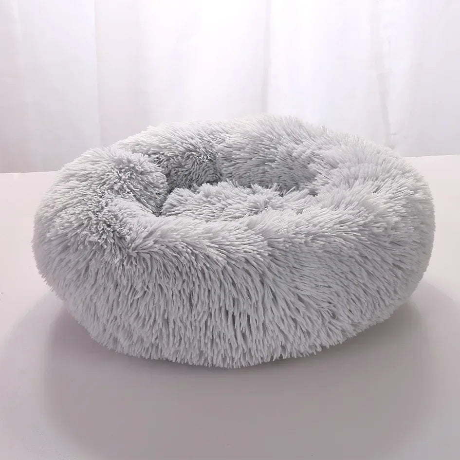 "Light grey premium dog bed offering comfort for pets, featuring plush design and elevated edges for head and neck support."