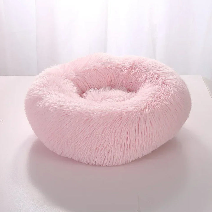 "Light grey premium dog bed offering comfort for pets, featuring plush design and elevated edges for head and neck support."