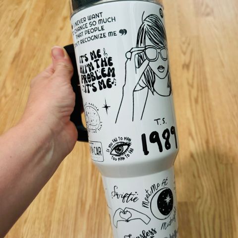 "Limited edition stainless steel tumbler with custom design, handwritten lyrics, vibrant colors, and ergonomic handle."