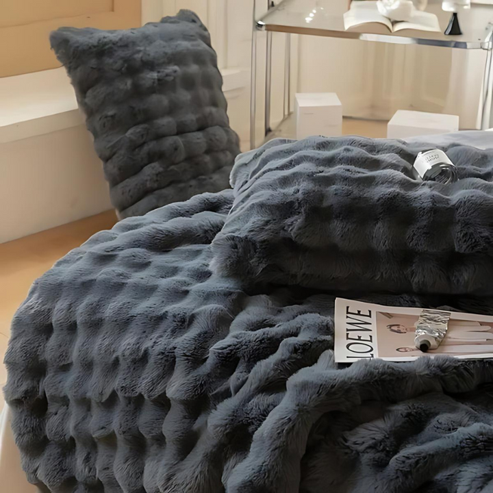 "Luxurious double-sided fleece and faux fur blanket for ultimate warmth, soft texture; ideal bedding or decorative throw."