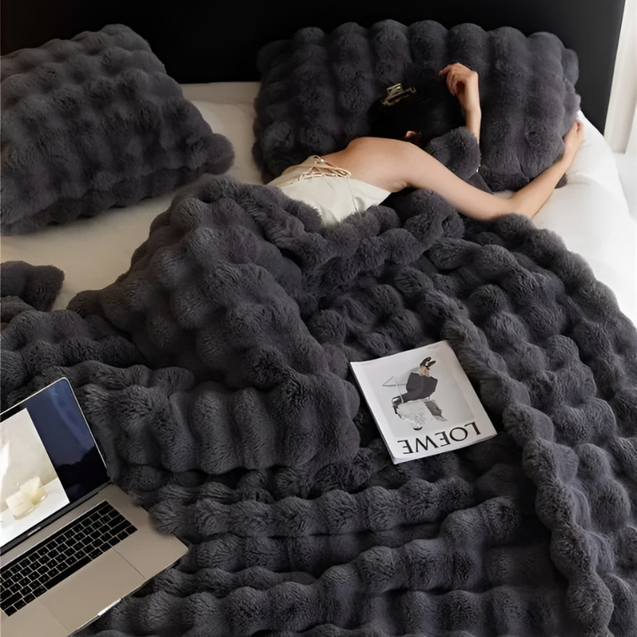 "Luxurious double-sided fleece and faux fur blanket for ultimate warmth, soft texture; ideal bedding or decorative throw."