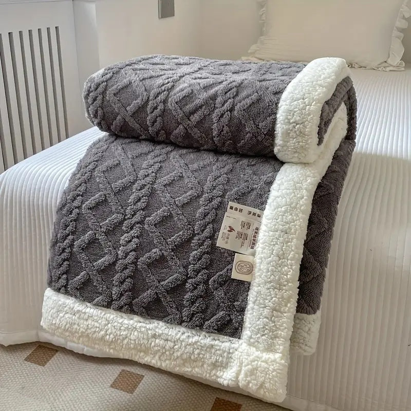 Luxurious sherpa blanket with plush, soft texture, reversible design; perfect for cozy all-season comfort and decoration.