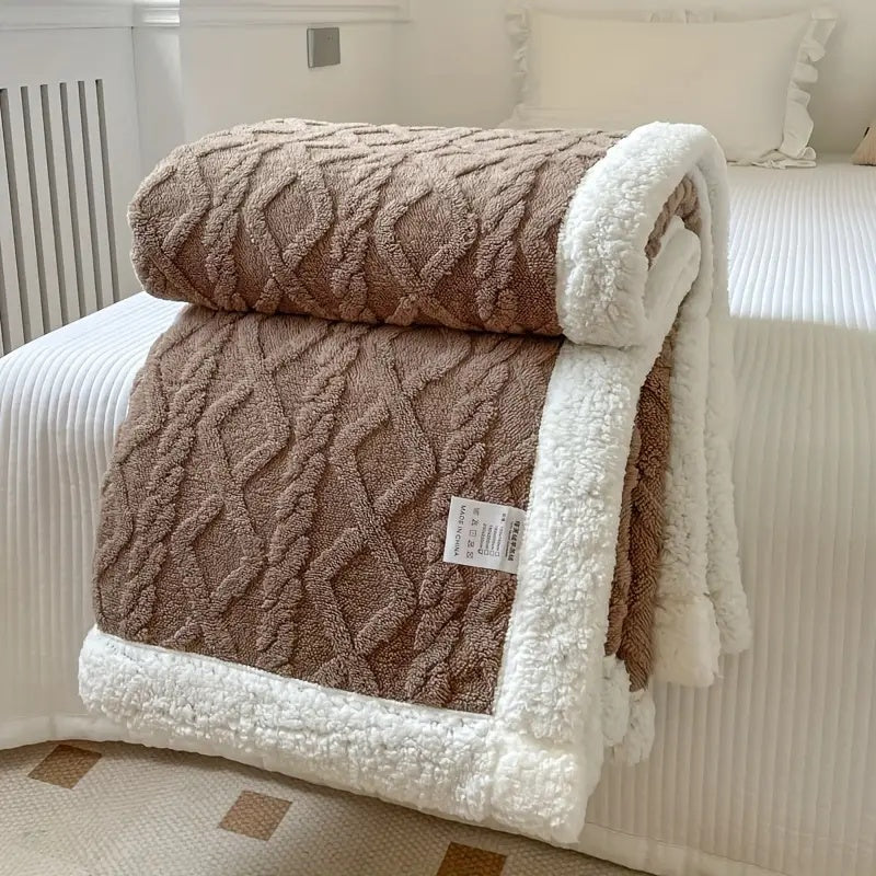 Luxurious sherpa blanket with plush, soft texture, reversible design; perfect for cozy all-season comfort and decoration.