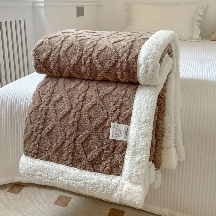 Luxurious sherpa blanket with plush, soft texture, reversible design; perfect for cozy all-season comfort and decoration.
