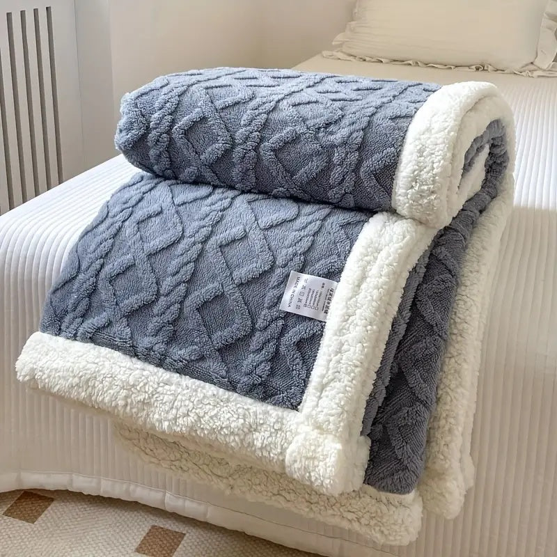 Luxurious sherpa blanket with plush, soft texture, reversible design; perfect for cozy all-season comfort and decoration.