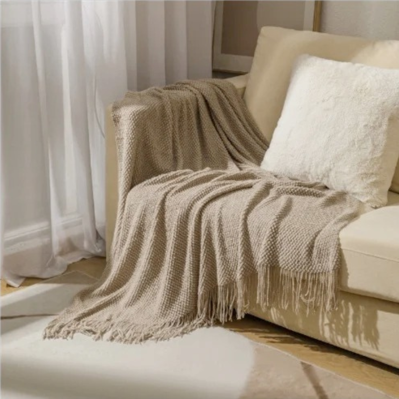 Luxury merino-style blanket with tassels and textured nubs; plush, elegant design perfect for home decor and warmth.