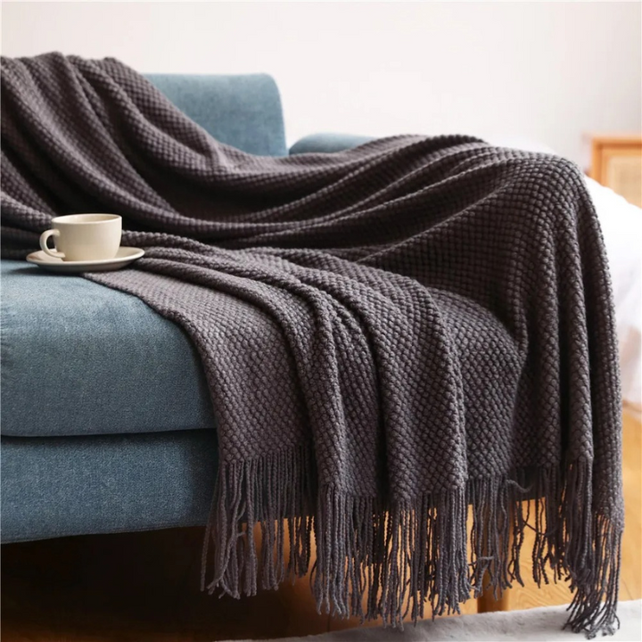 Luxury merino-style blanket with tassels and textured nubs; plush, elegant design perfect for home decor and warmth.
