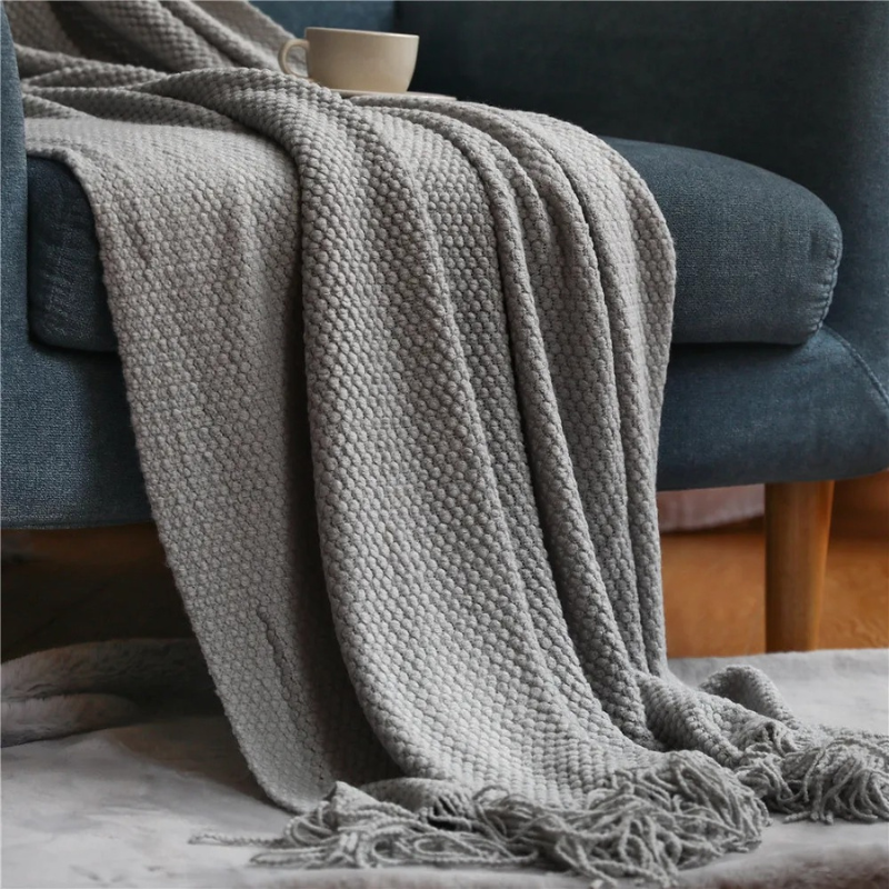 Luxury merino-style blanket with tassels and textured nubs; plush, elegant design perfect for home decor and warmth.