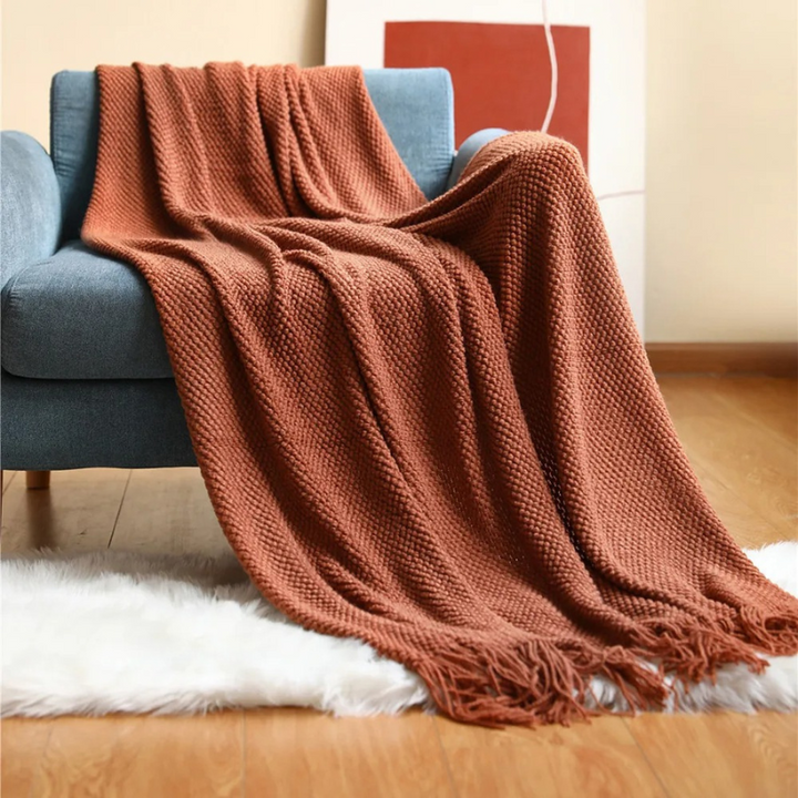 Luxury merino-style blanket with tassels and textured nubs; plush, elegant design perfect for home decor and warmth.