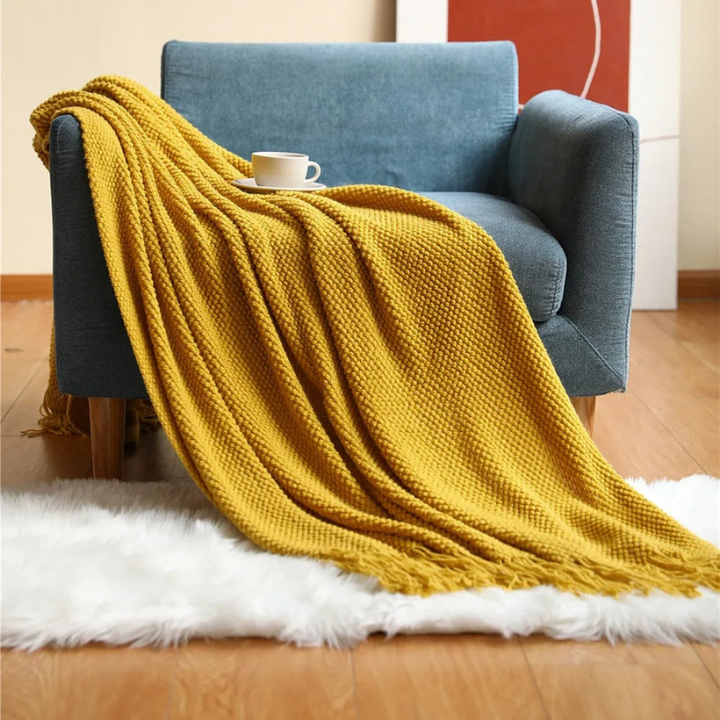 Luxury merino-style blanket with tassels and textured nubs; plush, elegant design perfect for home decor and warmth.
