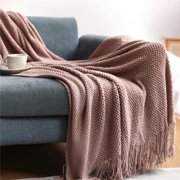Luxury merino-style blanket with tassels and textured nubs; plush, elegant design perfect for home decor and warmth.