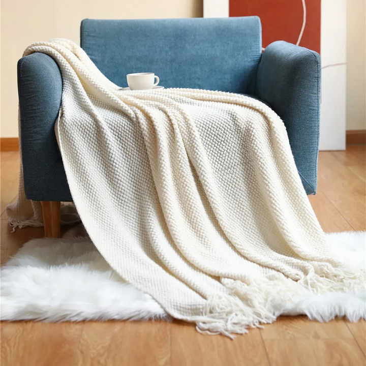 Luxury merino-style blanket with tassels and textured nubs; plush, elegant design perfect for home decor and warmth.