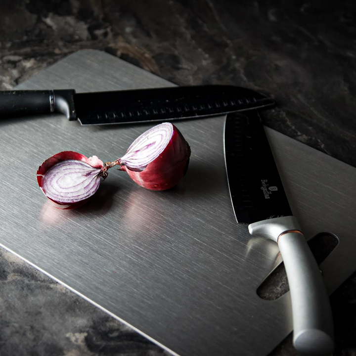 Medical grade titanium cutting board with non-porous silver surface, rounded edges, and ergonomic design for ultimate hygiene
