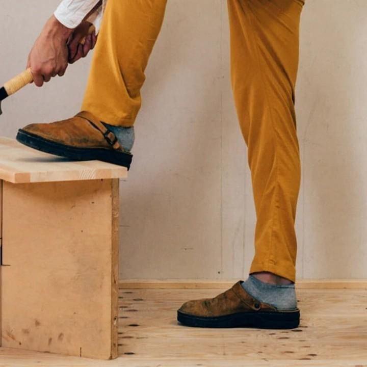 "Men's brown leather slippers, sleek design, breathable, ideal for indoor and outdoor wear, provide comfort and support."