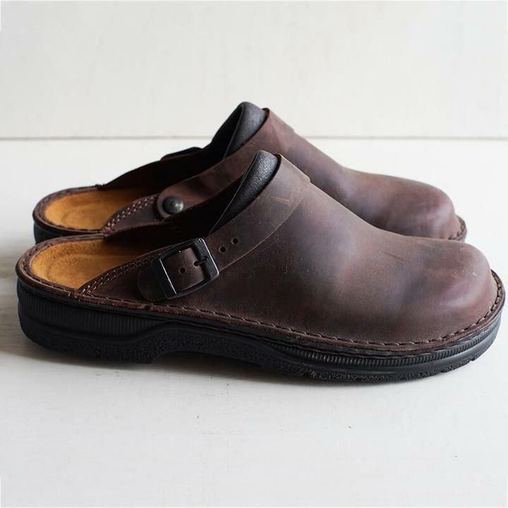"Men's brown leather slippers, sleek design, breathable, ideal for indoor and outdoor wear, provide comfort and support."