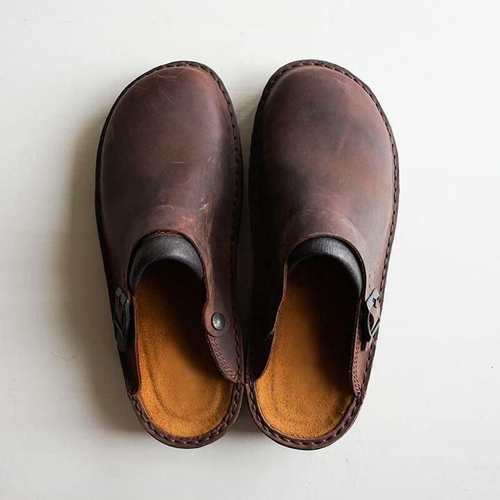 "Men's brown leather slippers, sleek design, breathable, ideal for indoor and outdoor wear, provide comfort and support."