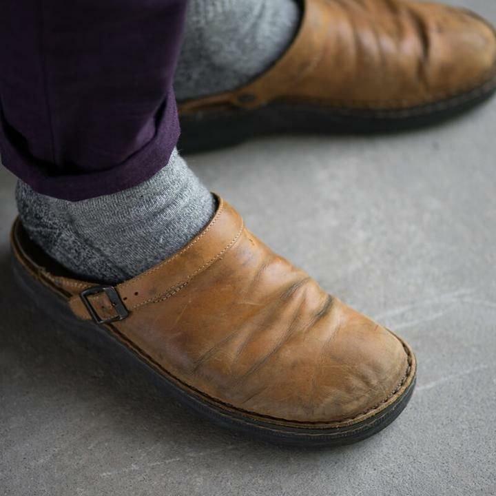 "Men's brown leather slippers, sleek design, breathable, ideal for indoor and outdoor wear, provide comfort and support."